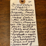 A handwritten wine tag on a wooden surface, featuring a printed header for Bernard Defaix 'Chablis' with detailed notes and a small price of 68.