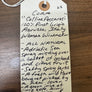 Handwritten wine label on a wooden surface