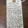 Handwritten label on a wooden surface