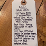 Handwritten tag on a wooden surface with wine description details.