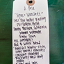 Handwritten product description tag on a green surface