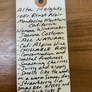 Handwritten wine label on a wooden surface
