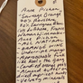 Wine label with handwritten notes on a wooden surface