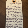 Handwritten tag with product description on a wooden surface