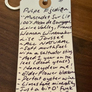 Handwritten wine label on a wooden surface
