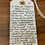 Handwritten wine label on a wooden surface