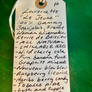 Handwritten tag on a green background with product description