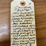 Handwritten tag with product description on a wooden surface