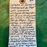 Handwritten wine label on a textured green background