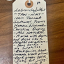 Handwritten label on a wooden surface