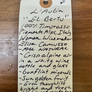 Handwritten wine label on a wooden surface
