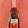 Bottle of Frisanit with a label held against a red background