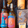 This box includes Vinovore Between Us wine, Vinovore Safari Sunset wine, P. F. Candle Co. Golden Hour candle, Crispy Dark Chocolate Orange Slices, Wild Yonder Botanical Bath Salts & Body Scrub (choose your pack) and an Acrylic Wine Stopper (choose your color).