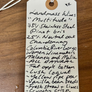 Handwritten wine label on a wooden surface