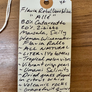 Handwritten wine label on a wooden surface