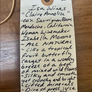 Handwritten wine label on a wooden surface