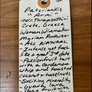 Handwritten wine label on a wooden surface