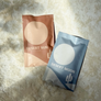 Two skincare product packages labeled 'Desert Sun' and 'Desert Moon' on a textured surface.