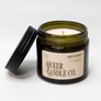 Candle in a jar with 'Queer Candle Co.' label on a white background