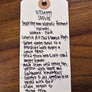 Handwritten tag on a wooden surface