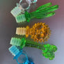 Assorted acrylic wine stoppers. Pick your faves! Bling ring in blue or clear, green palm tree or cactus, orange sun. Sold individually.