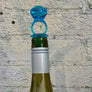 Assorted acrylic wine stoppers. Pick your faves! Bling ring in blue or clear, green palm tree or cactus, orange sun. Sold individually.