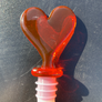 Assorted acrylic wine stoppers. Pick your faves! Bling ring in blue or clear, green palm tree or cactus, orange sun, red heart. Sold individually.
