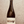 Bottle of wine held by a hand with a textured gray background