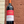 Bottle of Backsberg Cabernet Sauvignon wine held against a textured wall.