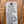 White tag with black text on a wooden surface