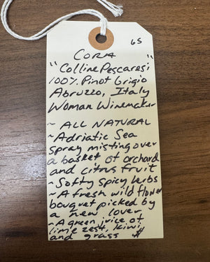 Handwritten wine label on a wooden surface