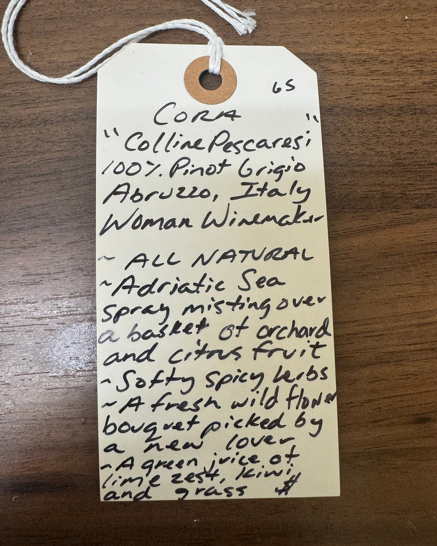 Handwritten wine label on a wooden surface