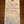 A handwritten wine tag on a wooden surface, detailing the winemaking process and characteristics of a red wine.
