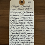 High Camp 100% Pinot Noir hand written tag on a wooden background