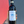 Bottle of Stroppiana Barolo wine held by a person with a tattooed arm against a red and gray background.