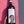 Wine bottle held against a pink and gray wall