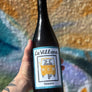 Bottle of La Villana Bianco wine in front of a colorful background
