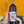 Bottle of j brix wine held by a hand with a colorful background