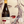 Bottle of Ronco Malo wine held in front of a stylized portrait.