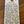 Handwritten tag on a wooden surface with product details.