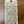 Handwritten tag with wine description on a wooden surface