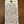 Handwritten tag on a wooden surface with product description