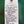 Handwritten product description tag on a green surface