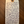 Handwritten tag with wine description on a wooden surface