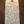 Handwritten tag with product description on a wooden surface