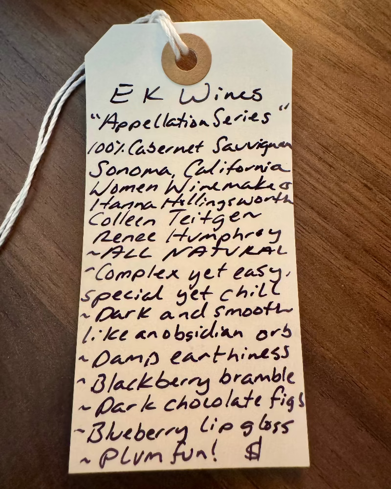 Handwritten tag from E K Wines on a wooden surface