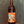 Wine bottle with a colorful label featuring a house and flowers against a dark background