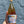 Hand holding a bottle of Rosé wine with a colorful label against a gray textured background