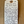 Handwritten tag on a wooden surface with product description