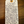 Handwritten tag on a wooden surface with product description